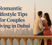 A romantic couple sits on a balcony overlooking the Dubai skyline at sunset, with the Burj Khalifa in the background and warm golden tones creating a peaceful, intimate mood.